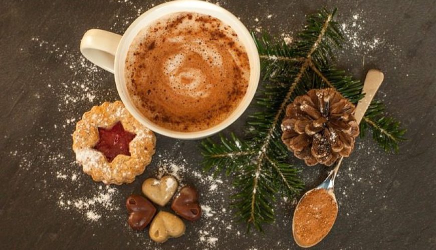 A cup of hot chocolate with a cookie and more